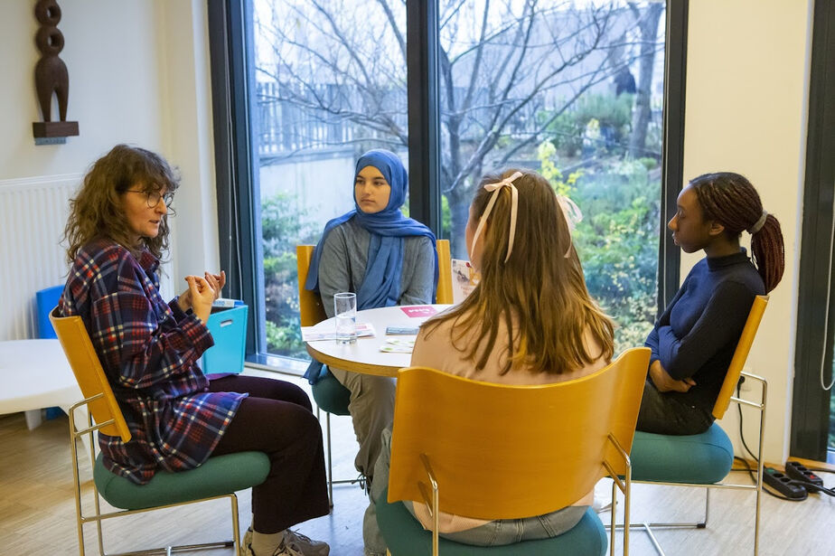 Eine Gruppe Jugendlicher im Gespräch mit einem "lebenden Buch"